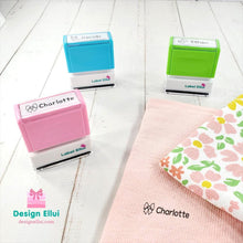 Load image into Gallery viewer, custom clothing stamp, custom name stamp, personalized clothing stamp, personalized name stamp, clothing name stamp, name clothing stamp, pre-inked stamp, self-inking stamp, flash stamp, textile stamp, fabric stamp, clothes stamp, diaper stamp, school stamp, daycare stamp, camp stamp, name stamp, refill ink
