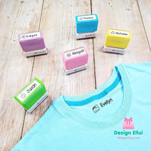 Load image into Gallery viewer, custom clothing stamp, custom name stamp, personalized clothing stamp, personalized name stamp, clothing name stamp, name clothing stamp, pre-inked stamp, self-inking stamp, flash stamp, textile stamp, fabric stamp, clothes stamp, diaper stamp, school stamp, daycare stamp, camp stamp, name stamp, refill ink
